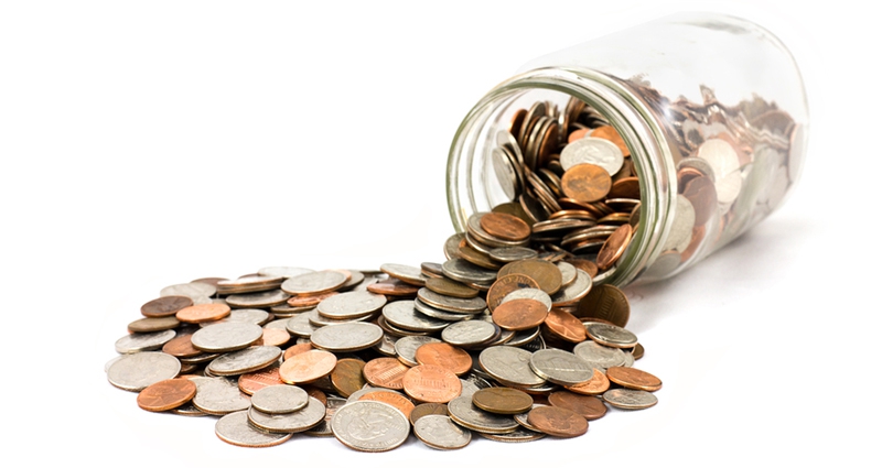 Jar with US coins spilling out