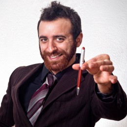 photo of man holding up a pen 