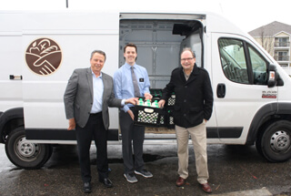 Bob Klocke handing over a crate of milk to Ozzie Phl