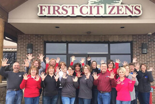 Mora First Citizens employees holding their 10 fingers up