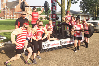 people dressed in red and white striped tank tops and black shorts