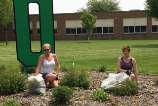 people dressed in red and white striped tank tops and black shorts