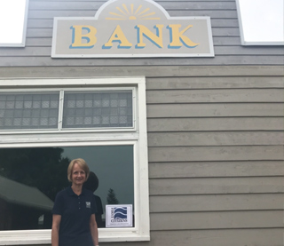 people sittiing on a parade float with blue and white umbrellas