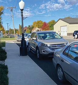 Mora First Citizens employees dressed in white short sleeve tshirts behind a Power Saver table